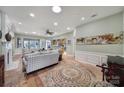 Spacious living room with hardwood floors, fireplace, and ample natural light at 55327 Derringer Ave, Fort Mill, SC 29707
