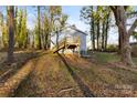 House with deck and storage building in wooded backyard at 612 Harry St, China Grove, NC 28023