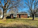 Front view of a ranch house with a large yard and mature trees at 813 S Zion St, Landis, NC 28088