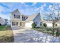 Two-story house with a gray roof, attached garage, and driveway at 8436 Dawson Ln, Locust, NC 28097