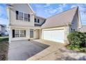 Two-story house with a beige exterior, attached garage, and landscaping at 8436 Dawson Ln, Locust, NC 28097