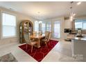 Dining area with red rug, and wooden table, near kitchen at 9027 Daring Ct, Charlotte, NC 28215