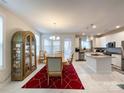 Bright dining area with a wooden table and access to the kitchen at 9027 Daring Ct, Charlotte, NC 28215