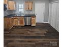 Modern kitchen with wood cabinets, stainless steel appliances, and dark countertops at 104 Rice St, Kannapolis, NC 28081