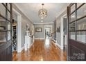 Bright and spacious entryway with hardwood floors and wine storage at 1105 Hadley Park Ln, Weddington, NC 28104