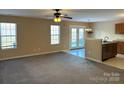 Living room with carpet, ceiling fan and access to kitchen at 2215 Ballingarry Dr, Statesville, NC 28625