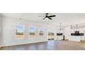 Bright and airy living room with hardwood floors, kitchen, and sliding door access to the backyard at 3025 Swallowtail Ln, Kannapolis, NC 28083