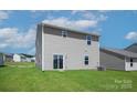 Two story house back elevation with sliding glass doors and backyard view at 3266 Maple Ridge Dr, Gastonia, NC 28052