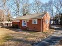 Side view of a brick ranch house with driveway at 408 Elizabeth St, Gastonia, NC 28054
