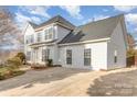 Two-story house with white siding, gray roof, and driveway at 5110 Osage Cir, Charlotte, NC 28269