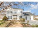 Two-story house with white siding, gray roof, and landscaping at 5110 Osage Cir, Charlotte, NC 28269