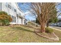 Landscaped front yard with trees and shrubs at 5110 Osage Cir, Charlotte, NC 28269