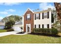 Two-story house with brick and siding, attached garage, and landscaped yard at 7724 Autumnview Ct, Huntersville, NC 28078