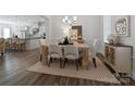 Bright dining room features a large table and hardwood floors at 82112 Standing Oak Dr, Charlotte, NC 28278
