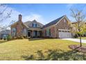Brick front home with a two-car garage and well-manicured lawn at 82112 Standing Oak Dr, Charlotte, NC 28278