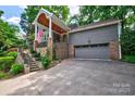 Gray house with brick accents, stone steps, and a two-car garage at 92 Heritage Dr, Clover, SC 29710