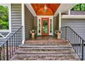 Inviting covered entryway with a red door and brick steps at 92 Heritage Dr, Clover, SC 29710