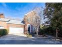 Inviting brick townhome with attached garage and landscaping at 9451 Bonnie Briar Cir, Charlotte, NC 28277
