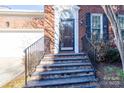 Brick front steps leading to the home's entrance with black railings at 9451 Bonnie Briar Cir, Charlotte, NC 28277