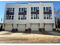 Three-unit townhome building with modern design and attached garages at 1225 E 34Th St # Csw0419, Charlotte, NC 28205