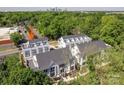 Aerial view showcases stylish townhomes nestled among mature trees, with the city skyline in the distance at 1227 E 34Th St # Csw0420, Charlotte, NC 28205