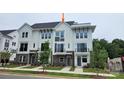 Charming, new construction townhome featuring a modern white and brick facade with private balconies and well manicured landscaping at 1227 E 34Th St # Csw0420, Charlotte, NC 28205