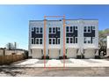 Rear exterior of a townhome with garages, concrete driveways and a mix of white and gray siding at 1227 E 34Th St # Csw0420, Charlotte, NC 28205
