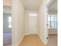Bright entryway featuring hardwood floors, a transom window, and views into adjacent rooms at 3111 Vermillion Dr, Harrisburg, NC 28075