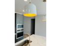 Modern kitchen featuring stylish pendant lights, stainless steel appliances, and sleek countertops at 3111 Vermillion Dr, Harrisburg, NC 28075