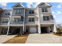 Three-unit townhome building with attached garages and landscaping at 3116 Butler Hill Dr, Matthews, NC 28105