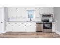 Renovated kitchen featuring white cabinets and stainless steel appliances at 320 Brown Rd, China Grove, NC 28023