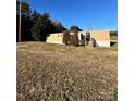 Tan mobile home with wooden steps and a grassy hill at 34&20 Shorty Miller Rd, Taylorsville, NC 28681