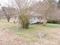 Side view of the house showcasing its simple design and yard at 374 Zion Church Rd, Mount Gilead, NC 27306