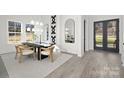 Bright dining room with modern light fixtures and hardwood floors at 3830 Mill Run, Terrell, NC 28682