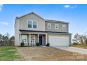Two-story house with gray siding, a two-car garage, and rocking chairs on the porch at 40 Harvest Ridge Dr, Hickory, NC 28601