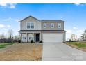 Two-story house with gray siding, a two-car garage, and rocking chairs on the porch at 40 Harvest Ridge Dr, Hickory, NC 28601
