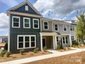 Charming two-story townhome featuring a welcoming front porch and a combination of vertical and horizontal siding at 4121 Walking Ridge Rd # 54, Charlotte, NC 28208