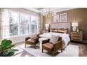 Spacious bedroom with large windows, two accent chairs, and hardwood floors at 4165 Eastover Glen Rd # 0337, Charlotte, NC 28269