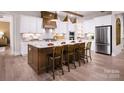 Modern kitchen boasts a large island, stainless steel appliances, and hardwood floors at 4165 Eastover Glen Rd # 0337, Charlotte, NC 28269