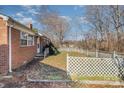 Side view of brick house with a yard and white fence at 437 Brevard St, Statesville, NC 28677