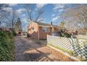 Brick ranch house with a driveway and a white fence at 437 Brevard St, Statesville, NC 28677