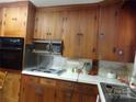 Classic kitchen with wood cabinets and built-in microwave at 5514 Grafton Pl, Charlotte, NC 28212