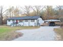 Newly renovated white ranch house with a carport and a gravel driveway at 6726 Lockhart Rd, Sharon, SC 29742