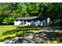 Charming one-story home with a well-maintained front yard and gravel driveway surrounded by mature trees at 6726 Lockhart Rd, Sharon, SC 29742