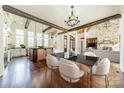 Dining area showcasing hardwood floors, wood beams, and view of the kitchen and great room at 9809 Saddle Ave, Waxhaw, NC 28173