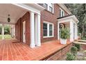 Front porch with brick flooring and white columns at 106 Patrick St, Gastonia, NC 28054