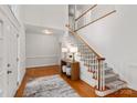 Two-story entryway with hardwood floors, staircase, and console table at 10843 Alexander Mill Dr, Charlotte, NC 28277