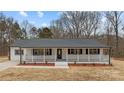 Charming ranch house featuring a front porch and well-manicured lawn at 12337 Grier Pl, Matthews, NC 28105