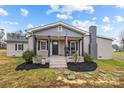 Gray brick ranch house with a front porch, rocking chairs, and landscaping at 1278 Burrell Rd, Clover, SC 29710
