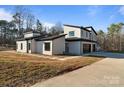 Contemporary home with attached garage and landscaped yard at 15650 Youngblood Rd, Charlotte, NC 28278